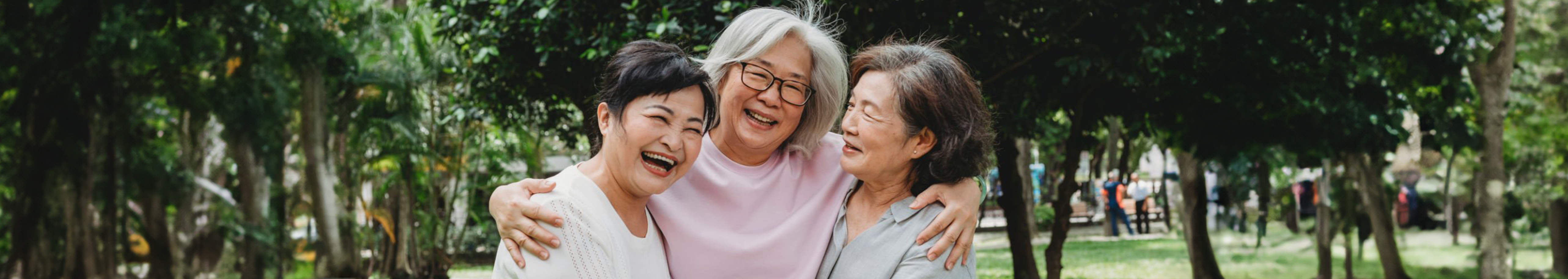 Three happy women hugging each other