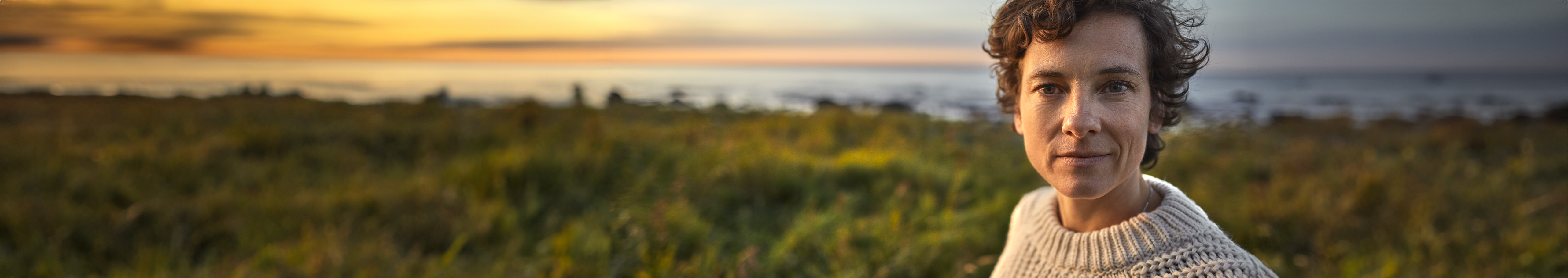 Banner image with a woman with wrinkles around her eyes and cheeks.
