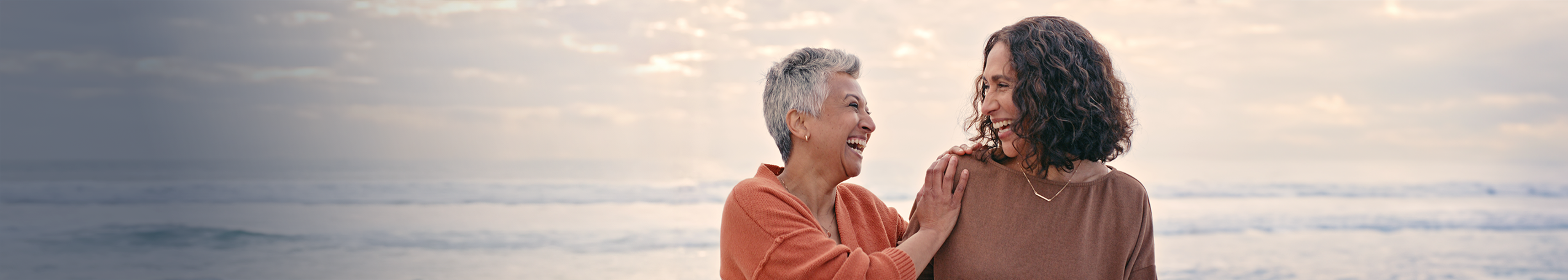 A banner of two happy women laughing.