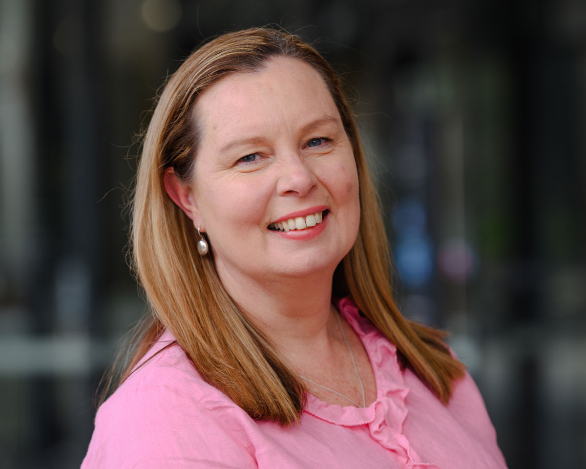 Portrait of A woman smiling wearing a pink top